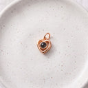 Love You Forever Projection Charm in rose gold on a ceramic plate