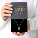 Small Heart Projection Necklace in silver in a Love Jewelry gift box, seen from above