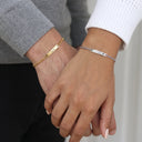 Couple Engraved Bracelets worn by a couple, gold and silver