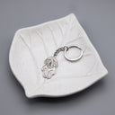 Silhouette Pet Photo Engraved Keychain in silver on a leaf dish