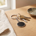 Magic Heat Keychain in silver with keys on a table