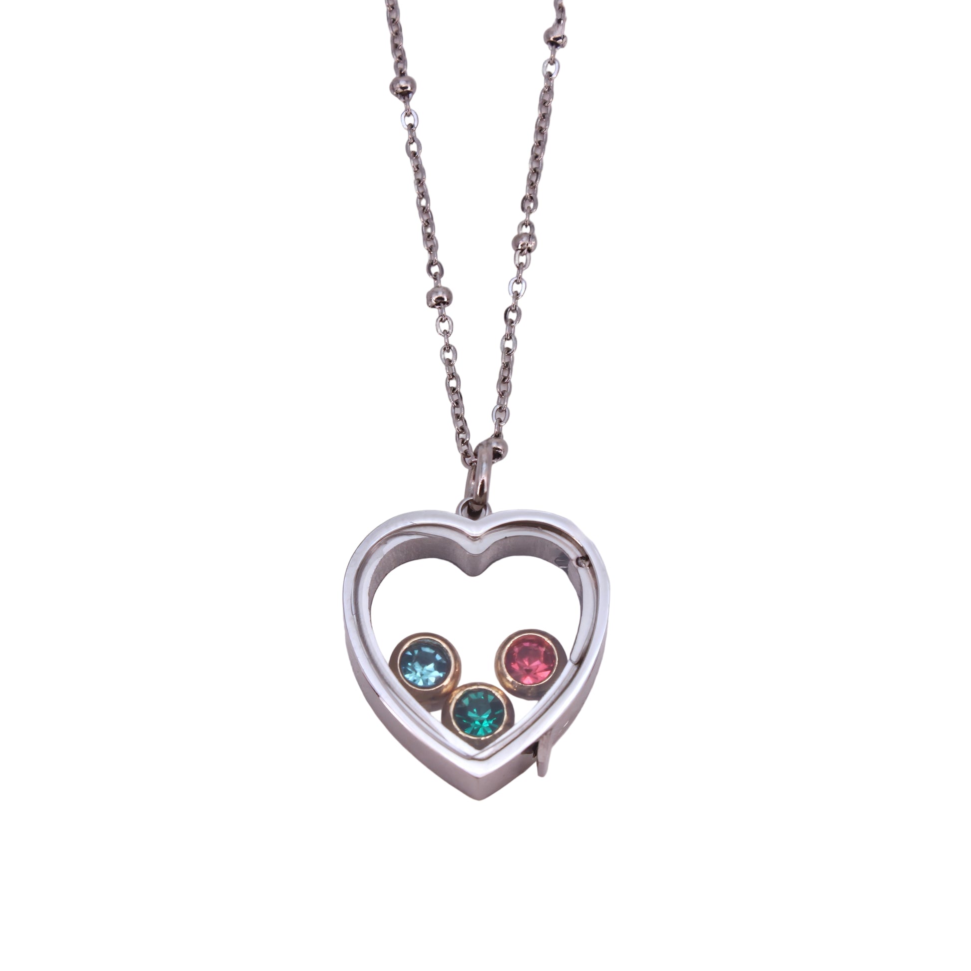 Heart-shaped pendant with three colored stones on a light pink background