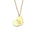 Gold heart-shaped necklace with a house and sun design on a light gray background