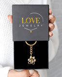 Paw Print Memorial Projection Keychain in gold, presented in a Love Jewelry gift box