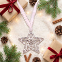 Shiny Star Projection Christmas Ornament in a festive Christmas flat lay