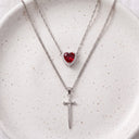 Heart & Sword Couple's Necklace in silver on a ceramic plate