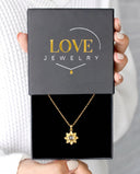 Minimalist Sunflower Projection Necklace in gold, presented in a Love Jewelry gift box