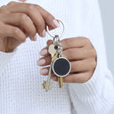 Magic Heat Keychain in silver with keys, held in hand