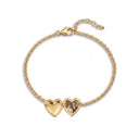 Gold heart photo locket bracelet open to reveal a custom photo inside, on a white background
