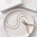 Permanent Bracelet Kit contents on a ceramic plate