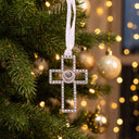 Forever Cross Projection Christmas Ornament hung on a decorated Christmas tree