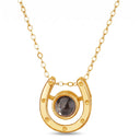 Horseshoe Lucky Charm Projection Necklace in gold, shown on a white background
