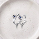 Minimalist Couple Projection Ring in silver on a ceramic plate