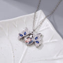 Butterfly Custom Photo Locket (open) in silver, on a leaf dish