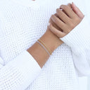 Permanent Bracelet Kit silver and gold bracelets stacked on the wrist