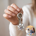 Paw Print Memorial Projection Keychain in silver with keys, held in hand