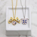 Butterfly Custom Photo Locket in silver and gold, on a marble cube
