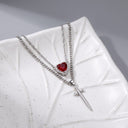 Heart & Sword Couple's Necklace in silver on a leaf dish