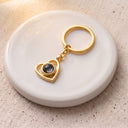 Heart Projection Keychain in gold on a round dish