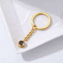 Minimalist Projection Keychain in gold on a jewellery tray