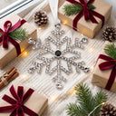 Snowflake Projection Christmas Ornament in a festive Christmas flat lay