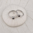 Minimalist Couple Projection Ring in silver on a shell