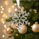 Snowflake Projection Christmas Ornament hanging on a Christmas tree