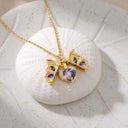 Butterfly Custom Photo Locket (open) in gold, on a shell