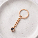 Minimalist Projection Keychain in rose gold on a ceramic plate