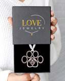 Delicate Paw Projection Christmas Ornament in silver, presented in a Love Jewelry gift box
