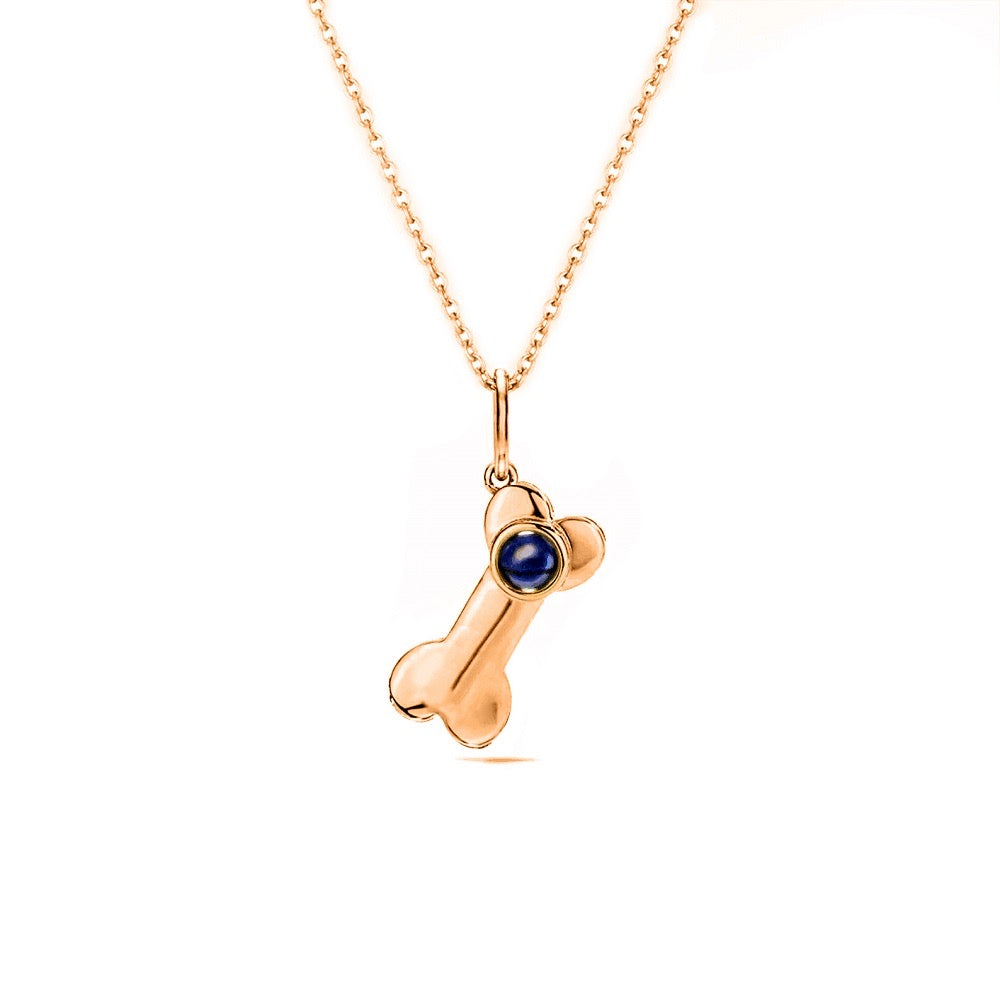 "heartwarming projection necklace: a necklace featuring a dog bone charm with a heartwarming projection."