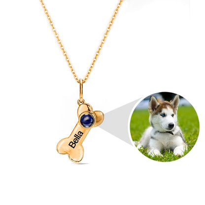 "Projection Keepsake Necklace: A meaningful necklace with a dog bone charm, designed to project cherished memories."