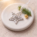 Shiny Star Projection Christmas Ornament on a round dish