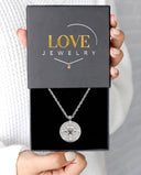 Round Compass Projection Necklace in silver, presented in a Love Jewelry gift box