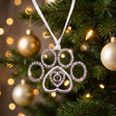 Delicate Paw Projection Christmas Ornament hanging on a Christmas tree