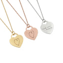 Three heart-shaped pendants on necklaces with different metals and inscriptions.