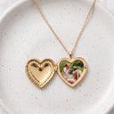 Silver heart photo locket necklace open to reveal a custom photo inside, on a white background
