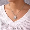 Woman wearing the silver Birthstone Heart Locket Necklace with the heart locket closed
