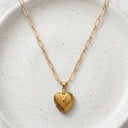 Gold All My Hearts Locket Necklace with heart locket closed, hanging on a white background
